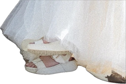 Cinderella's orthopedically correct sandals peeking out from under the dress hem